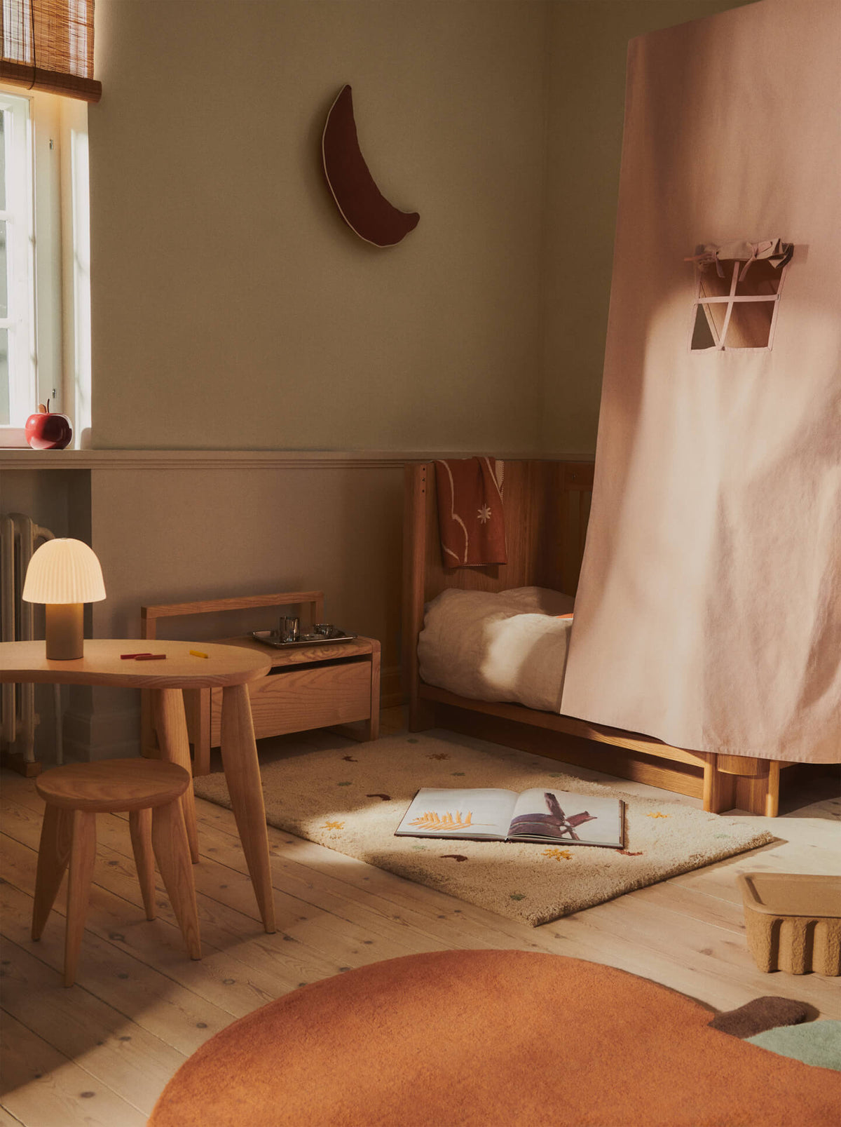 Skye rug shown beside a bed with toys