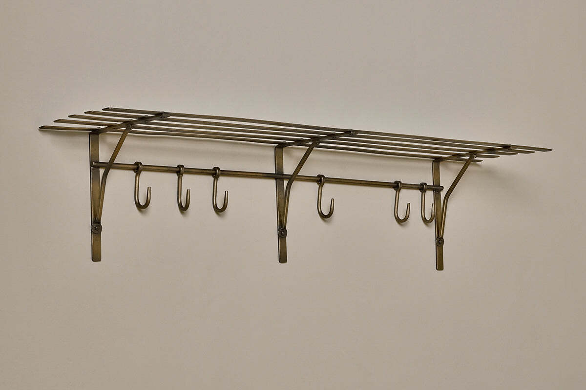 Close-up of the hammered antique brass finish on the Basti shelf