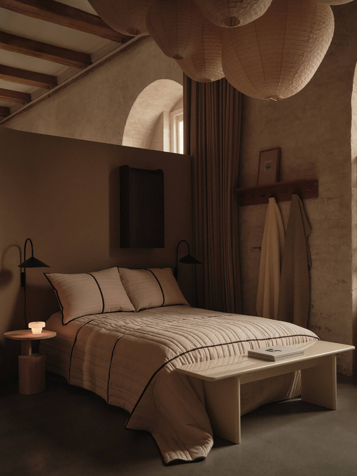 Vari bedspread styled on a bed in ferm LIVING's Copenhagen boutique