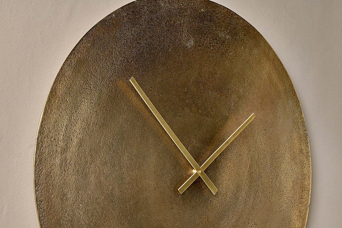 Okota clock hung on a neutral wall
