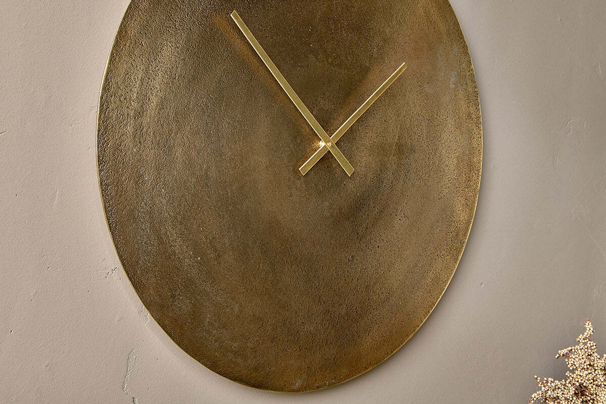 Close-up of the Okota clock's brass face and hands
