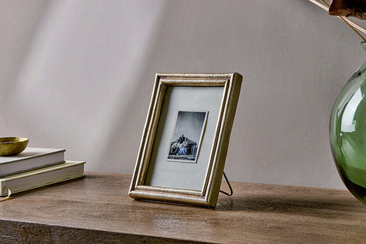 Pambani frame styled with other frames on a sideboard