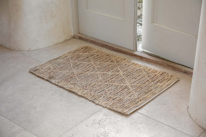 Nkuku Vandi natural jute doormat with woven diamond design, seen from above