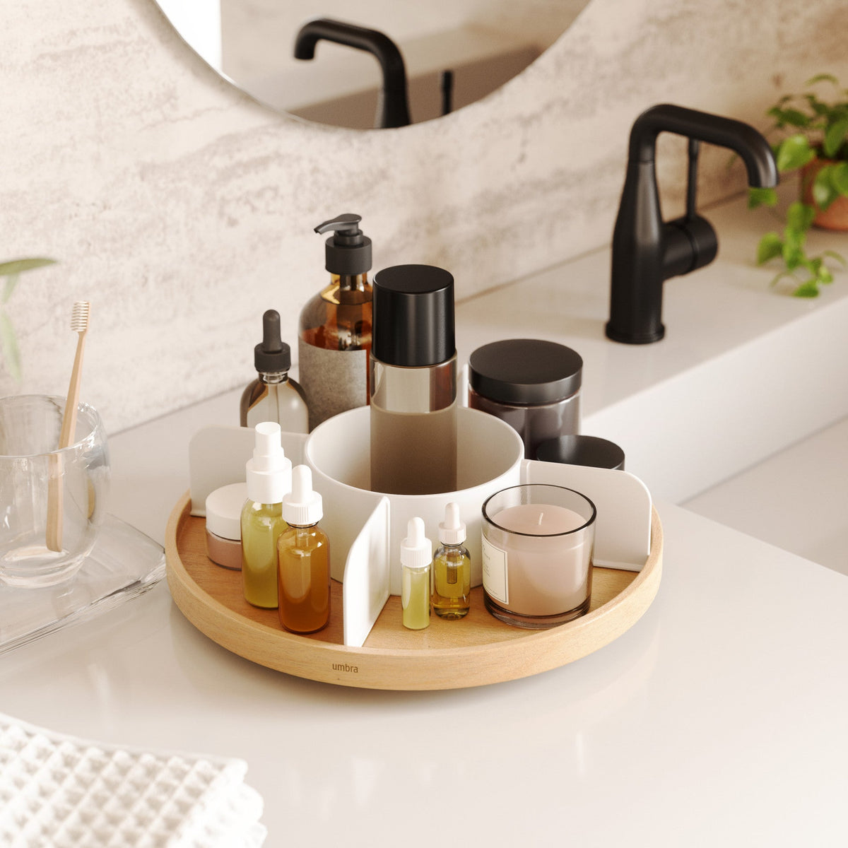 Bellwood lazy susan used for skincare bottles by a bathroom sink